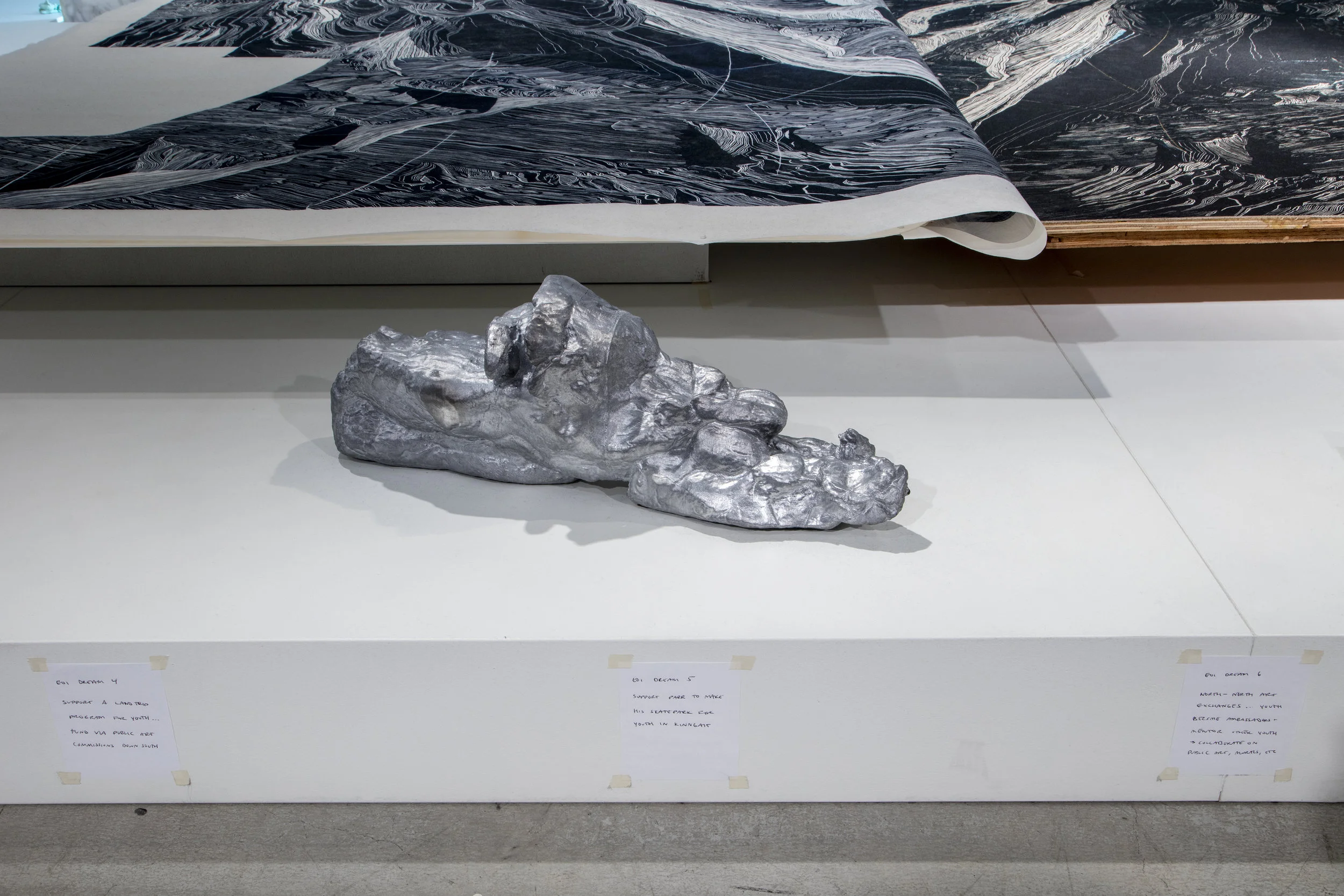 Aluminum cast of playdough snowmobile by Lachaolasie Akesuk (age 16), handwritten notes of Embassy of Imagination dreams, linocut block and print
