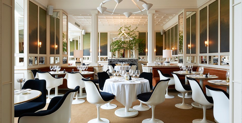 Upholstered Tulip chairs designed by Eero Saarinen in restaurant Lou-Lou in Paris.