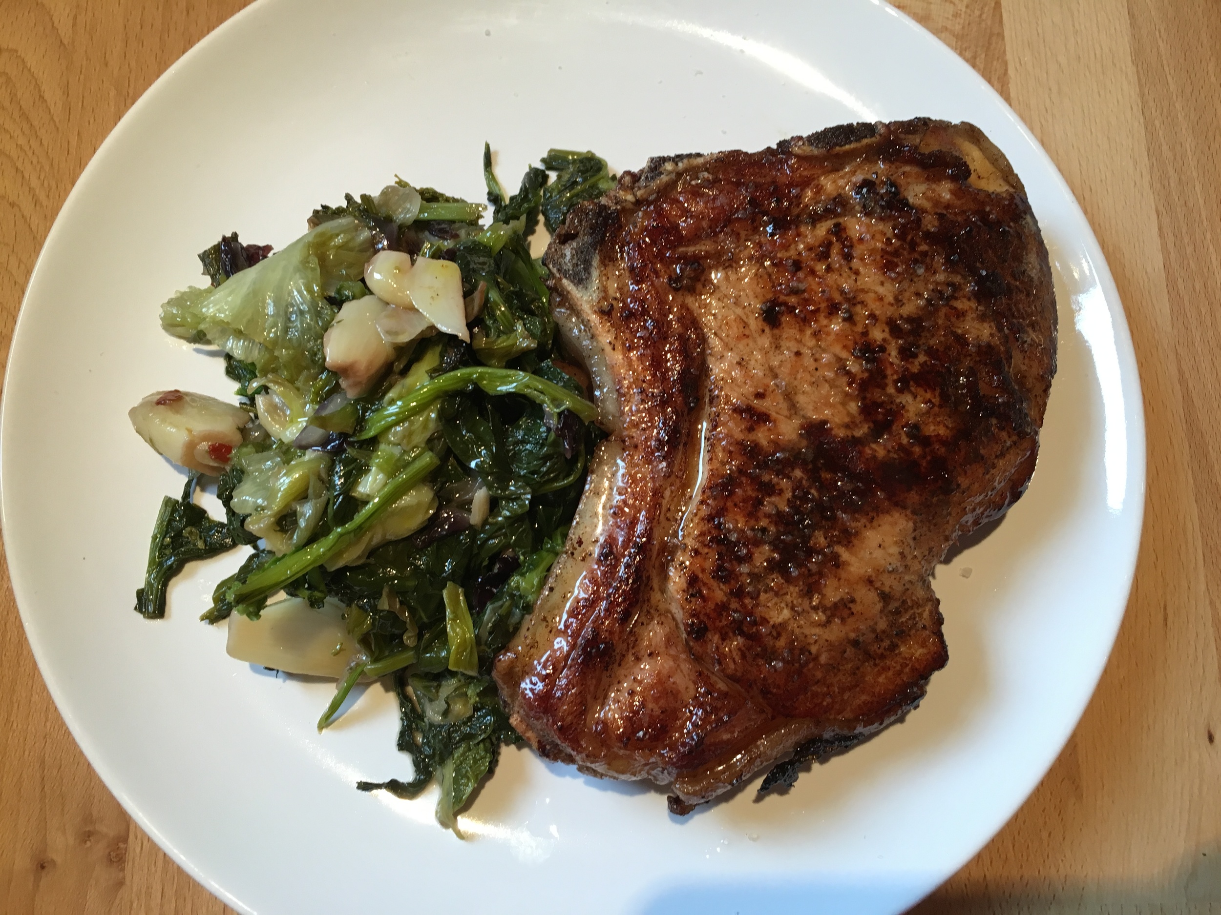Pan cooked veal chop and wilted greens