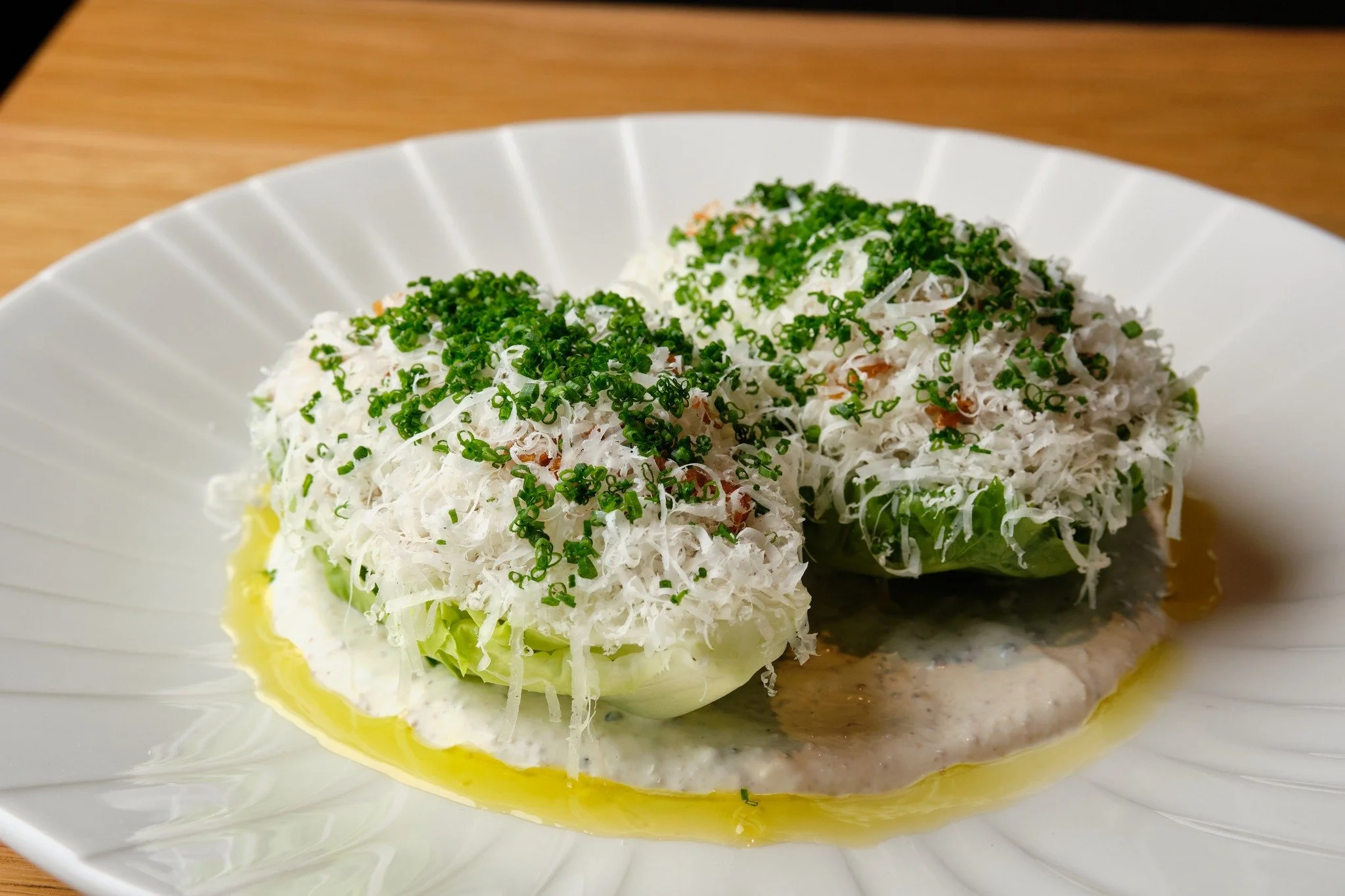 Expect the unexpected at Aria. We raise the bar when you order a salad! Take this little gem lettuce salad with grana padano, crispy shallots, truffle vinaigrette. 🥬