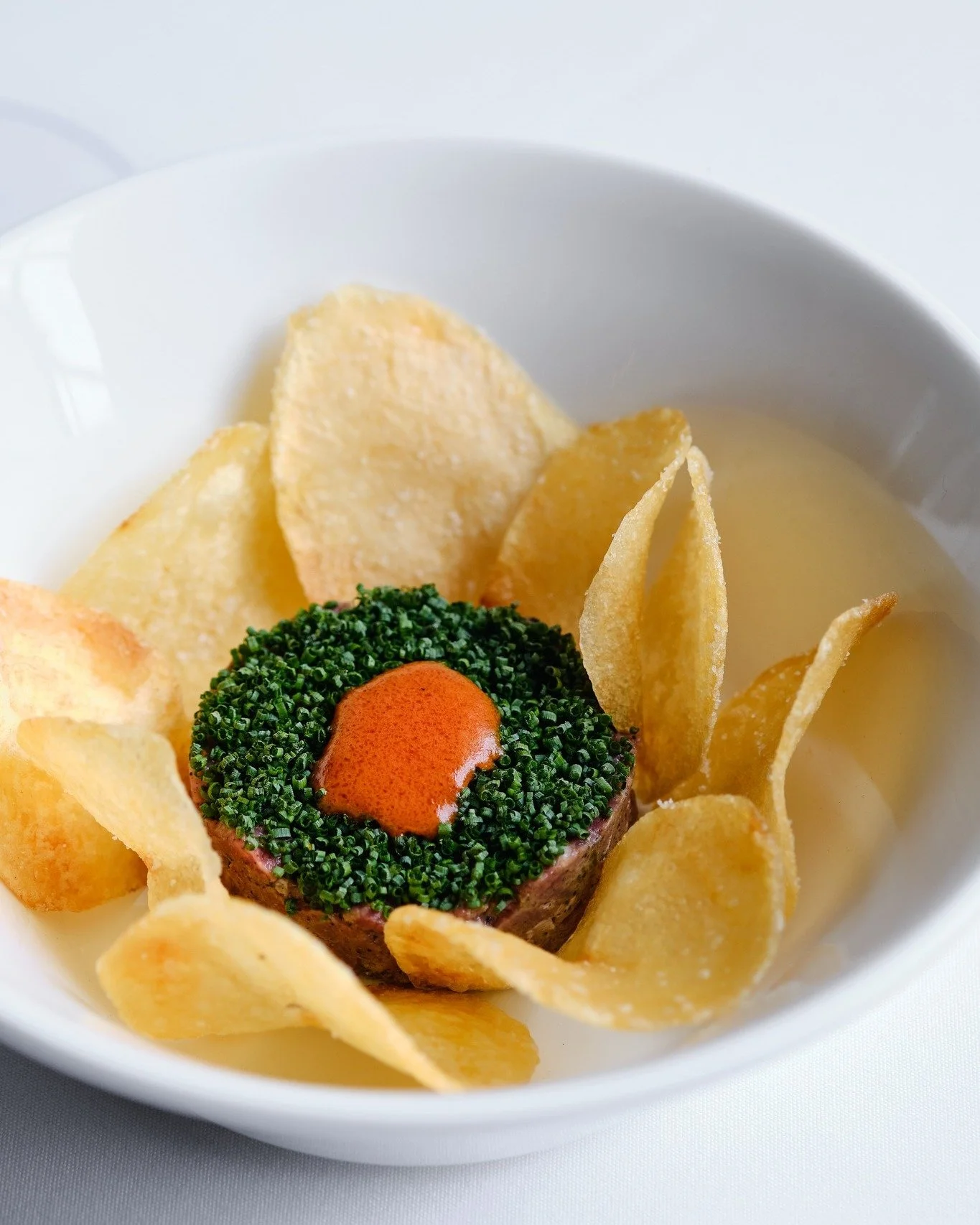 Beef tartare but make it with black truffle, piquillo pepper, chives and house chips.