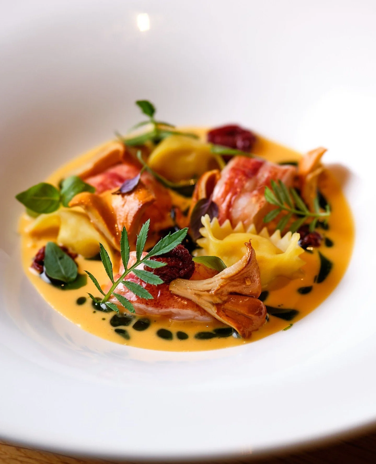 Summer has a way of finding its way onto the plate. Sweet corn agnolotti with butter-braised lobster, roasted chanterelles, basil, and tomato-kaffir lime nage.🦞