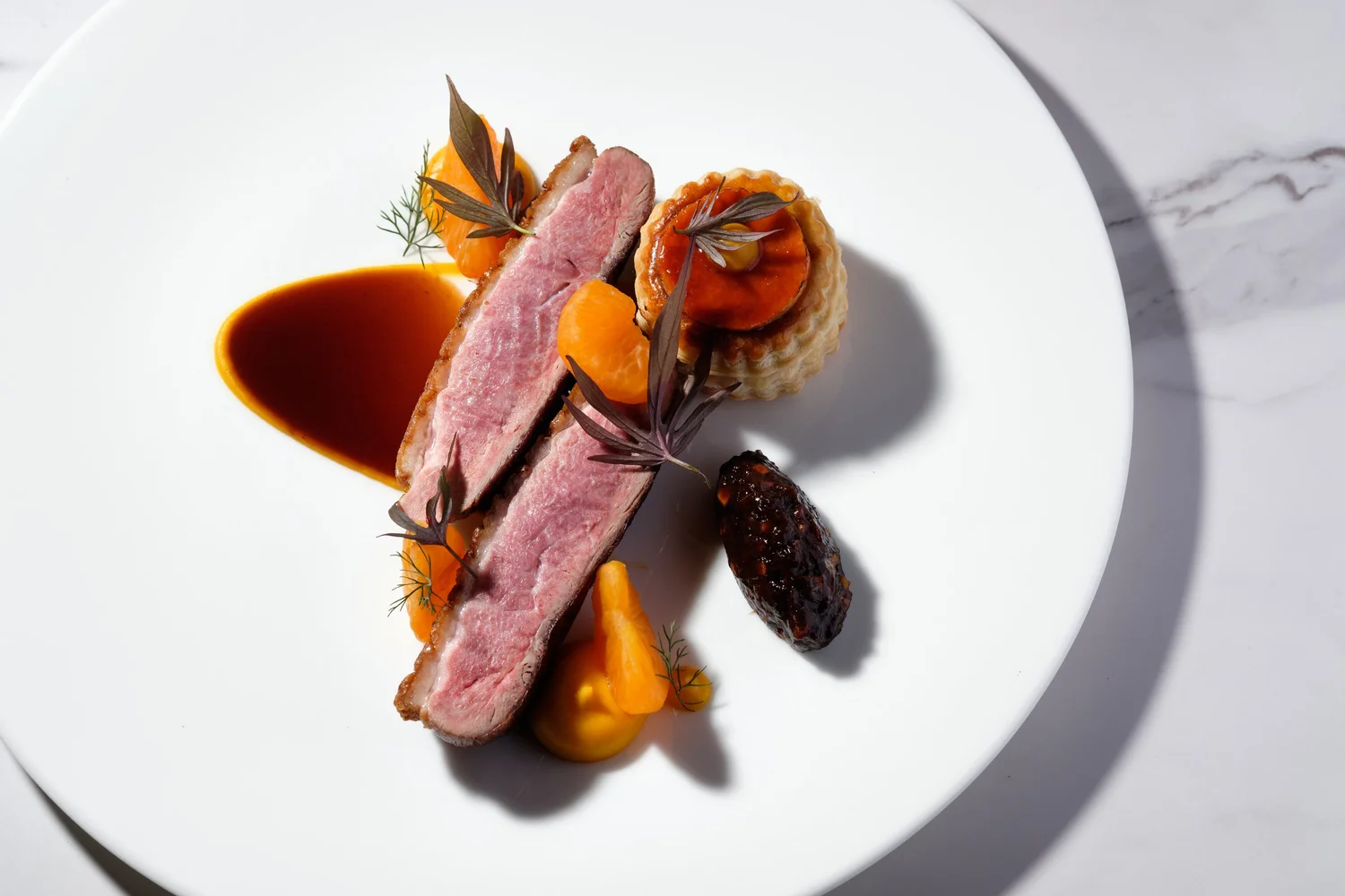 Breast of duck with mandarin and vol au vent at Aria