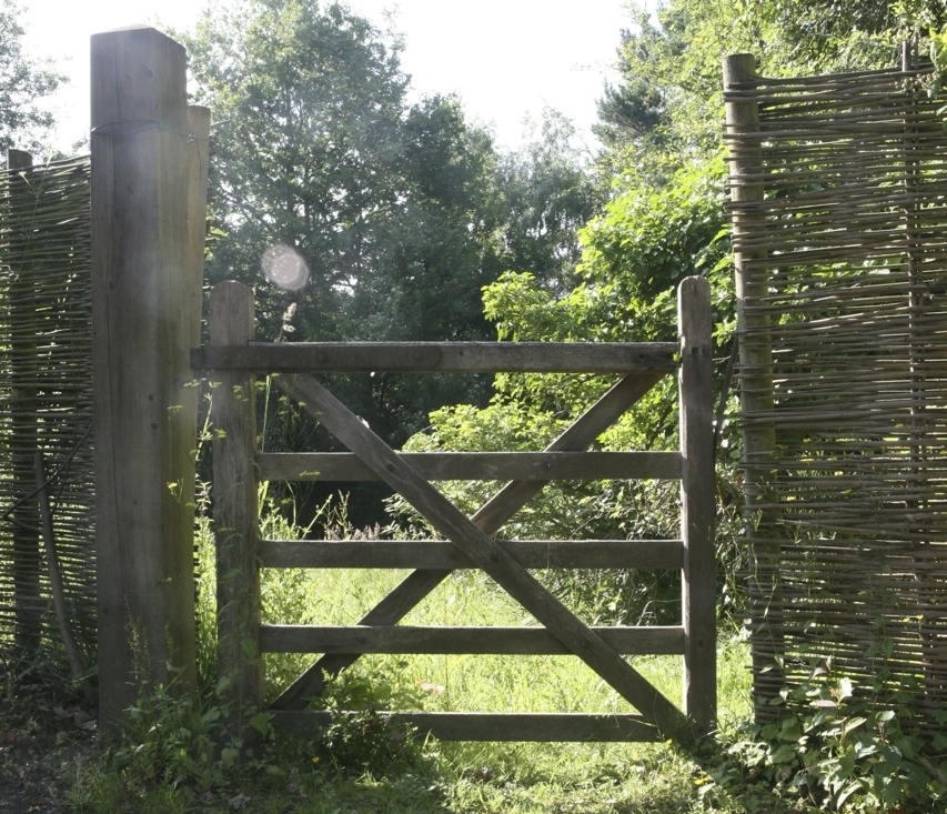  A simple wooden gate marks an entrance to the vegetable garden at Gravetye. 