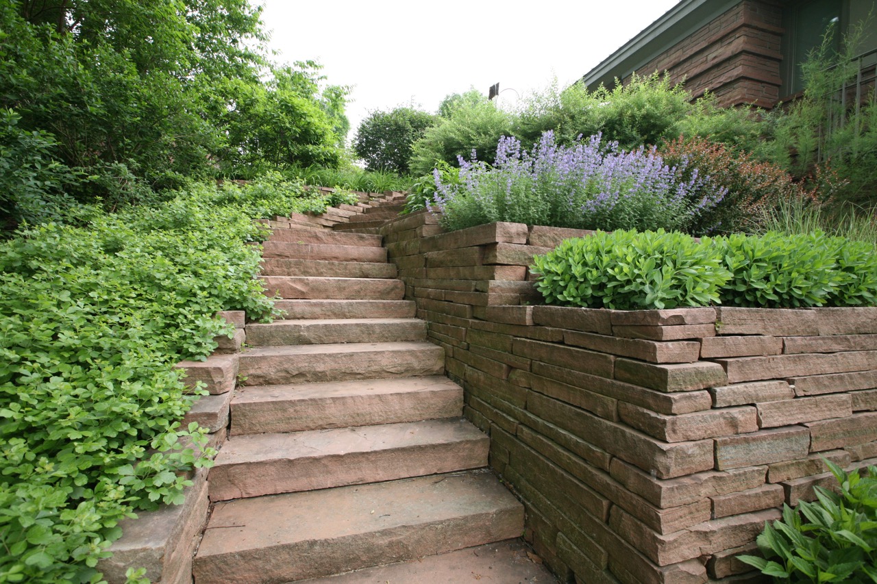    Stone steps and terraced planters take advantage of the natural slope.&nbsp; Note how their simplicity adds to the overall composition.&nbsp; Gro  -low sumac provides a connection to a more wild area below.     