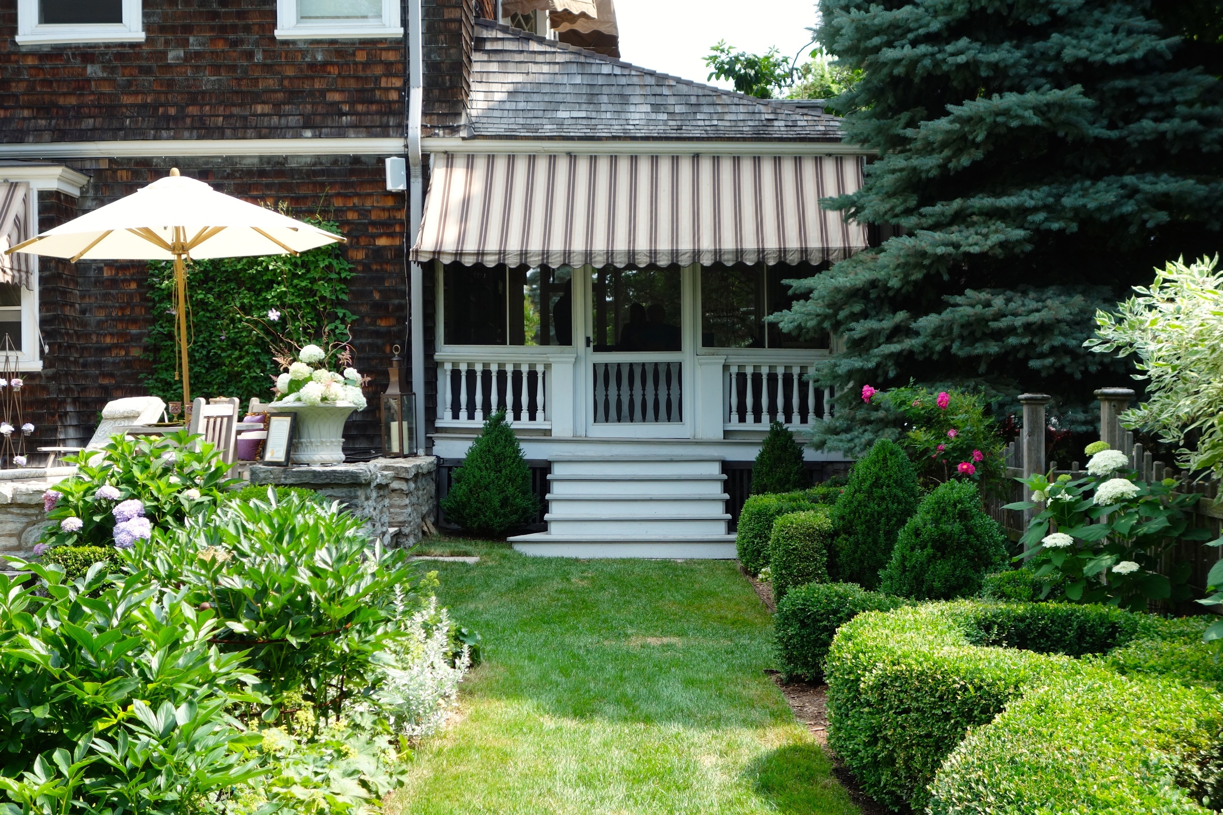   The garden has a strong connection to the house, including this grass path that extends from the porch steps.    