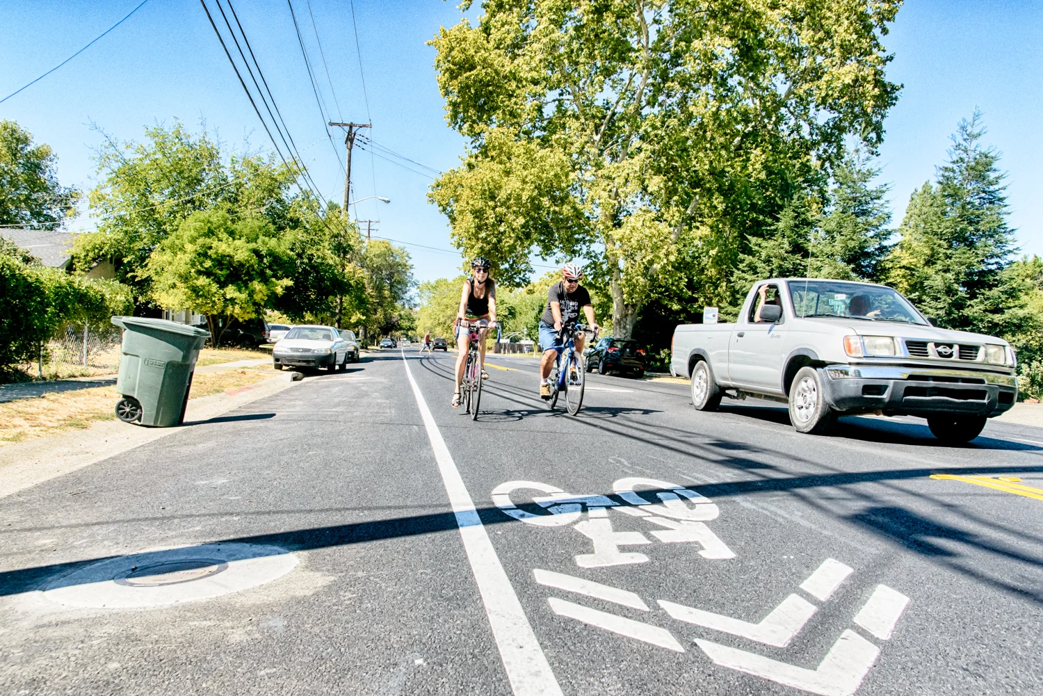©Carson Blume Truck passes cyclists claiming a safe riding position, while crossing over a double yellow at an intersection. BTW it is legal to ride side by side in places like South Street.