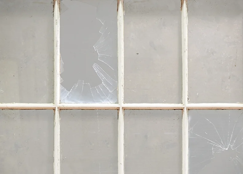 Detail, Broken Window. Broken windows theory is an academic theory proposed by James Q. Wilson and George Kelling in 1982 that used broken windows as a metaphor for disorder within neighborhoods. Kelling and Wilson suggested that a broken window or other visible signs of disorder or decay — loitering, graffiti, prostitution or drug use — can send the signal that a neighborhood is uncared for. So, they thought, if police departments addressed those problems, maybe the bigger crimes wouldn't happen. - Encyclopedia Britannica - NPR, 2016. “How A Theory of Crime and Policing Was Born, And Went Terribly Wrong”, November 1. The theory has instead resulted in what critics say is aggressive over-policing of minority communities, which often creates more problems than it solves. Such practices can strain criminal justice systems, burden impoverished people with fines for minor offenses, and fracture the relationship between police and minorities. It can also lead to tragedy: In New York in 2014, Eric Garner died from a police chokehold after officers approached him for selling loose cigarettes on a street corner. - PBS Frontline. 2016. “The Problem with ‘Broken Windows” Policing”, June 28.