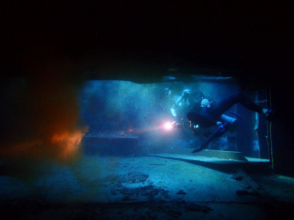 A diver investigation the inside of the Glenn Nusa