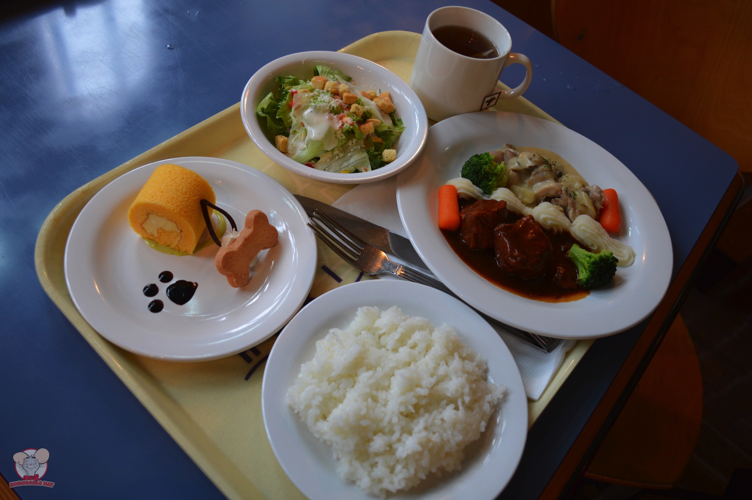 Caesar Salad, Braised Beef & Chicken with Cream Sauce, Banana Cream Roll Cake and a side of rice