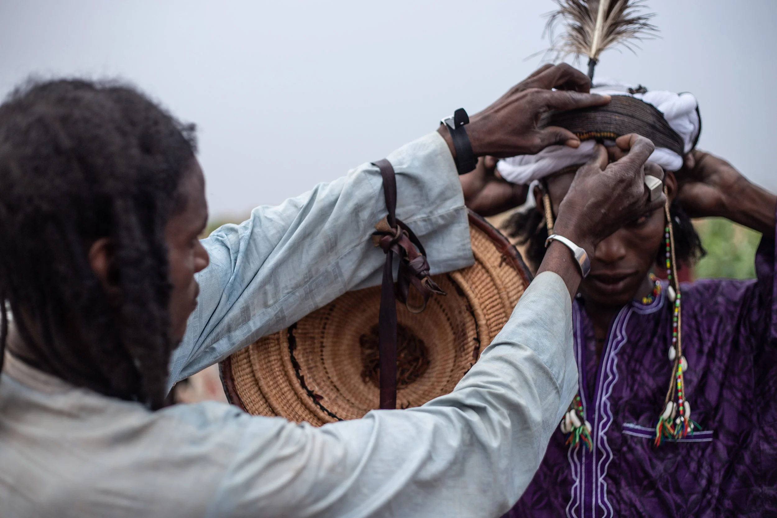 Wodaabe men prepare themselves with meticulous makeup and feathers in hopes of finding female companionship.