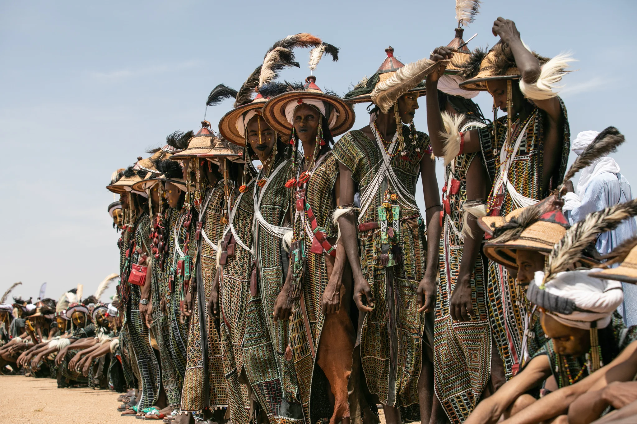 Young Wodaabe prepare themselves with meticulous makeup and feathers in hopes of finding a mate.
