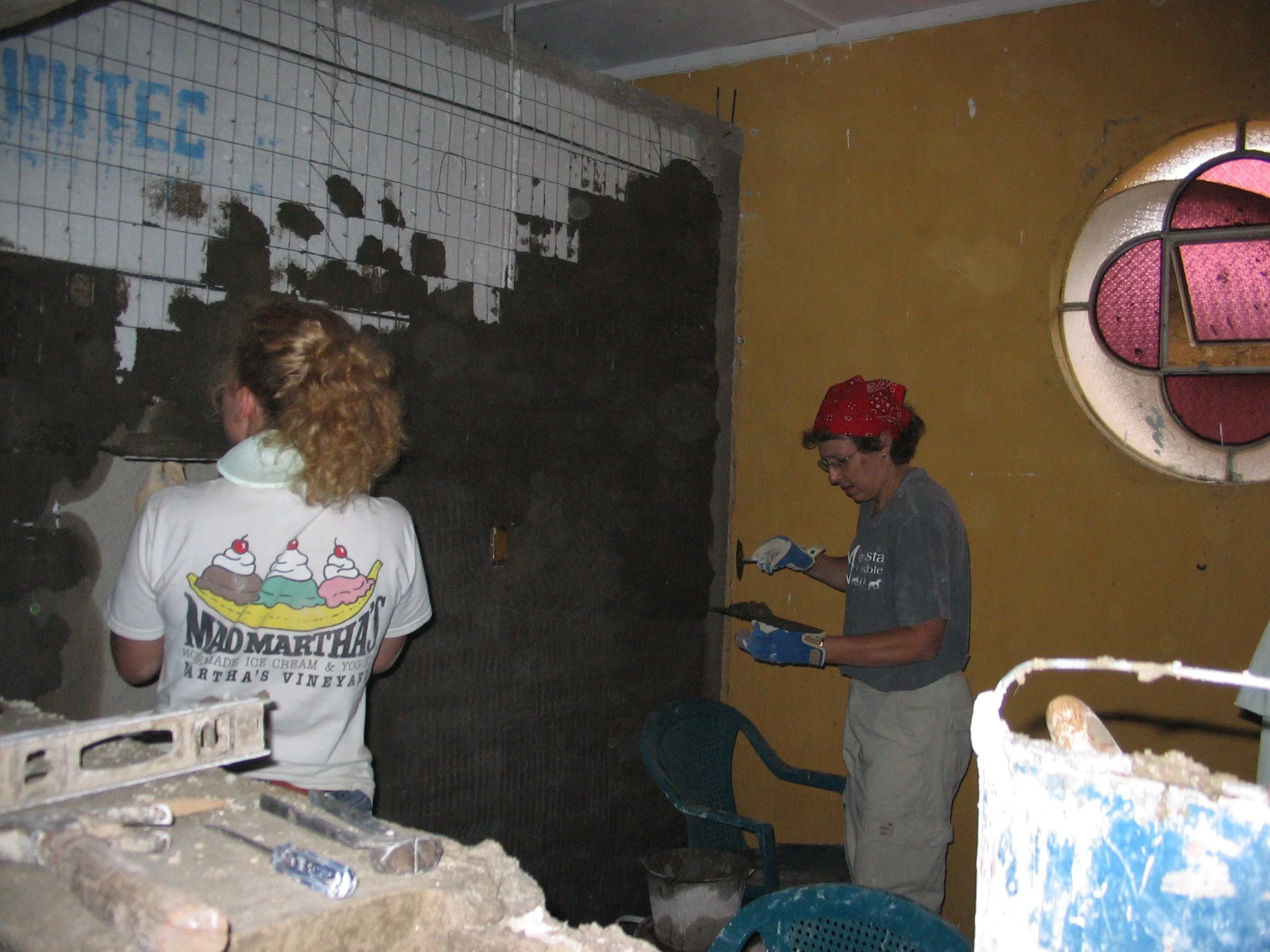 Claire and Jeneé stuccoing pharmacy.JPG