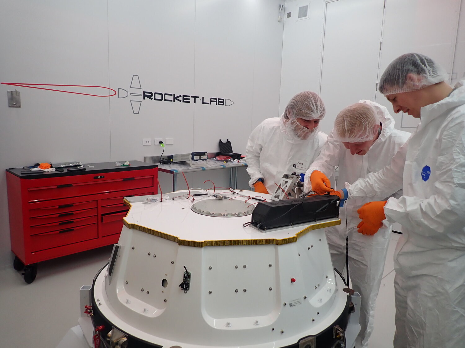 Alba Orbital integrating AlbaPod to Rocket Lab’s ‘Electron’ launch vehicle prior to Alba Cluster 2 launch (2019) (Left to right: Alan Easdale, Mechanical Engineer, Tom Walkinshaw, Founder &amp; CEO, &amp; Dr. Martin Dunn, Mechanical Engineer/Mission…
