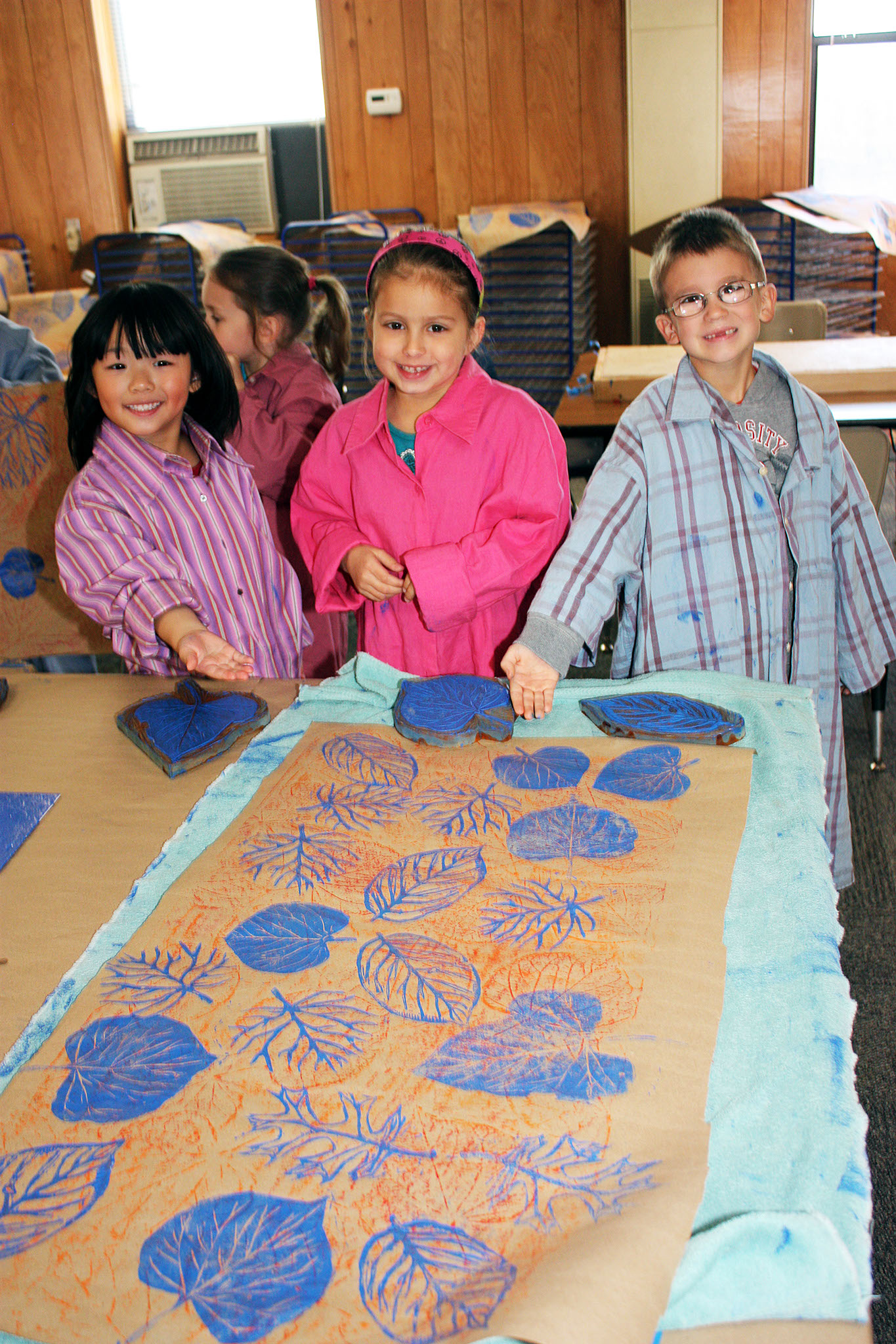 Students show off their handiwork at the Children's Summer Art Program.