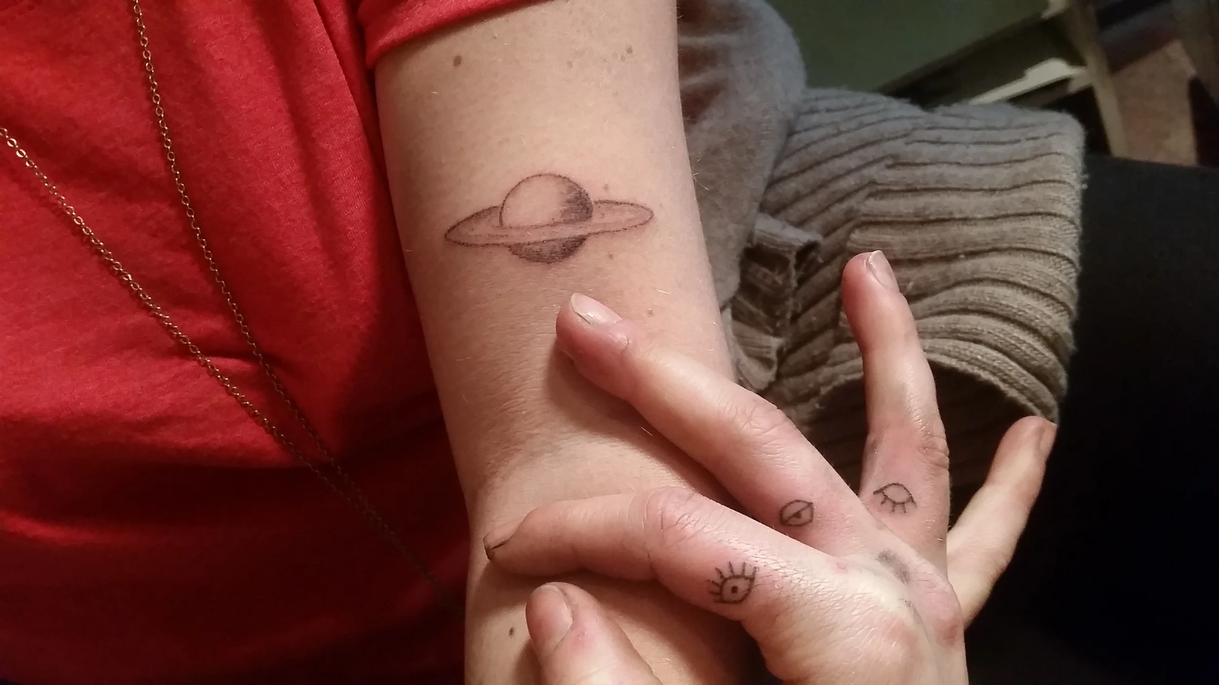 saturn tattoo on Elizabeth Jarrett // eye tattoos on Claire Brooks