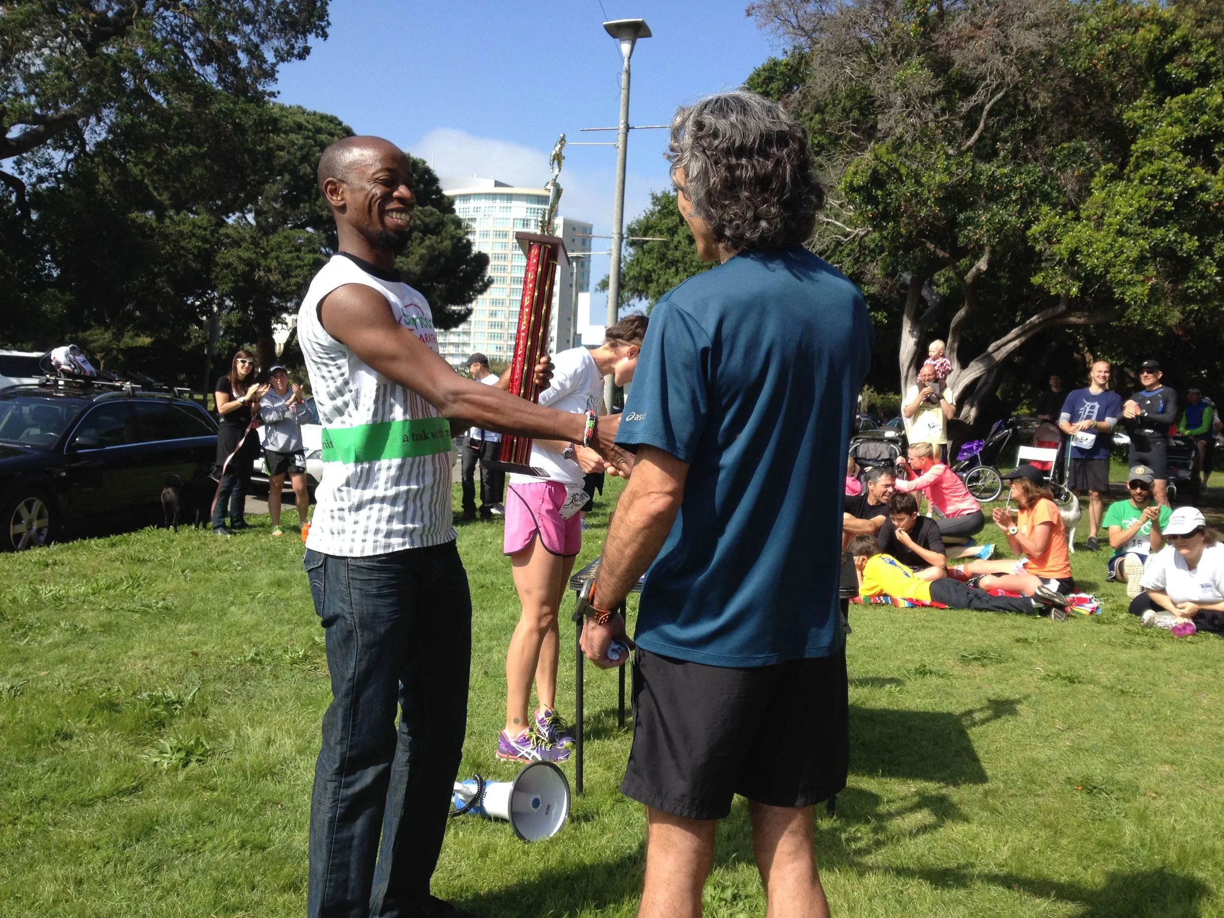 Dr. Nyamora (left) presenting a trophy to a race participant