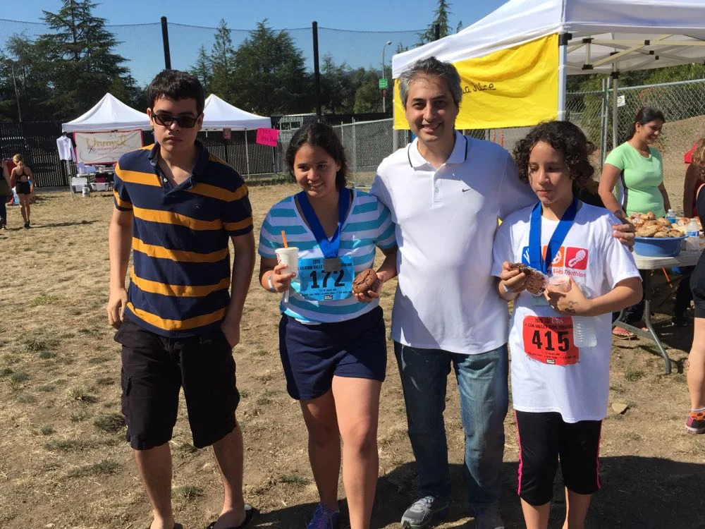 A proud parent shares the success and joy of his two competitive children Sasha and Andrea donning their triathlon medals