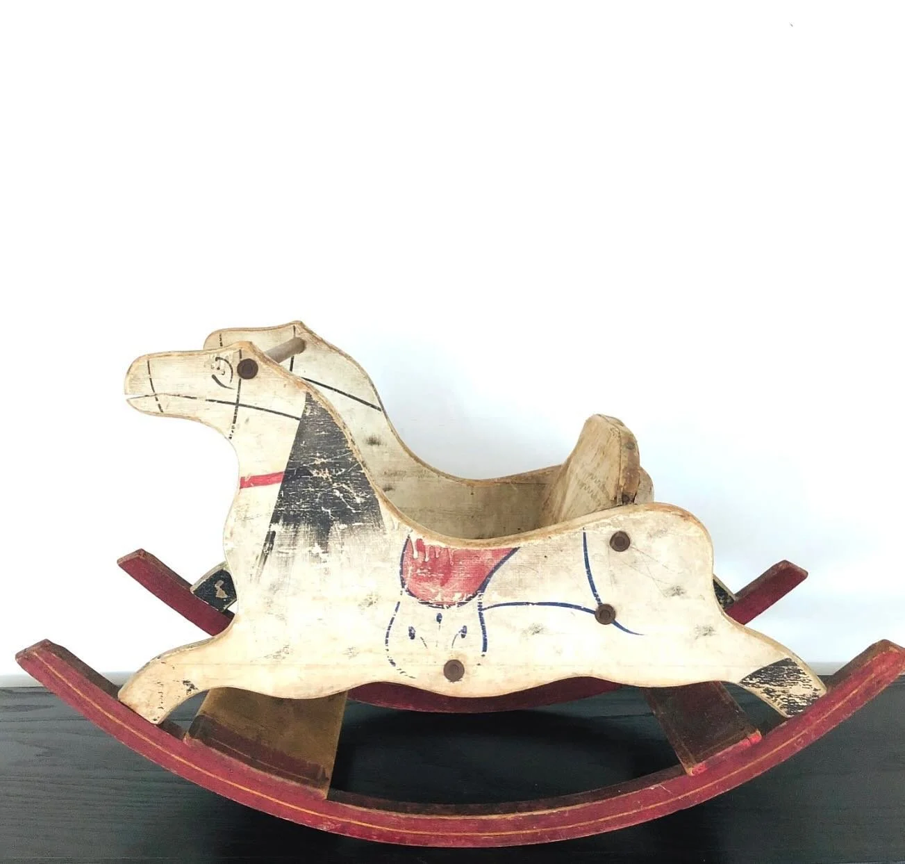 Primitive rocking horse, c. 19th century. 
32&rdquo; long x 18&rdquo; tall.
Rare upholstered chair.
Etsy link in bio