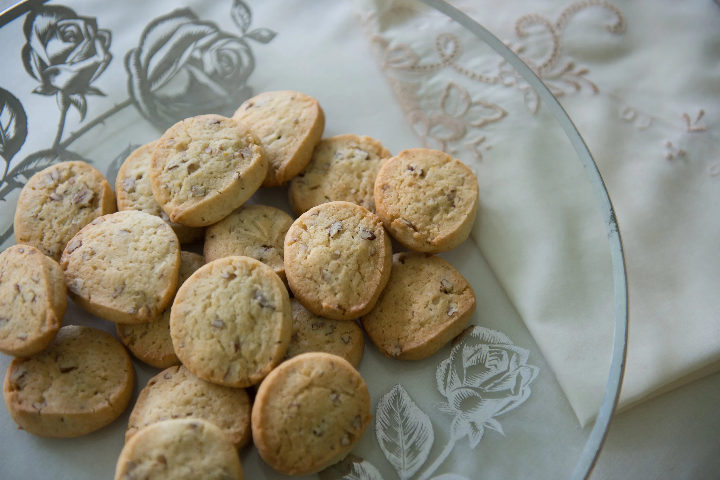  Lemon icebox cookies, made from a recipe that belonged to Lucille Burton, on a platter and with a linen napkin that both also belonged to Burton.