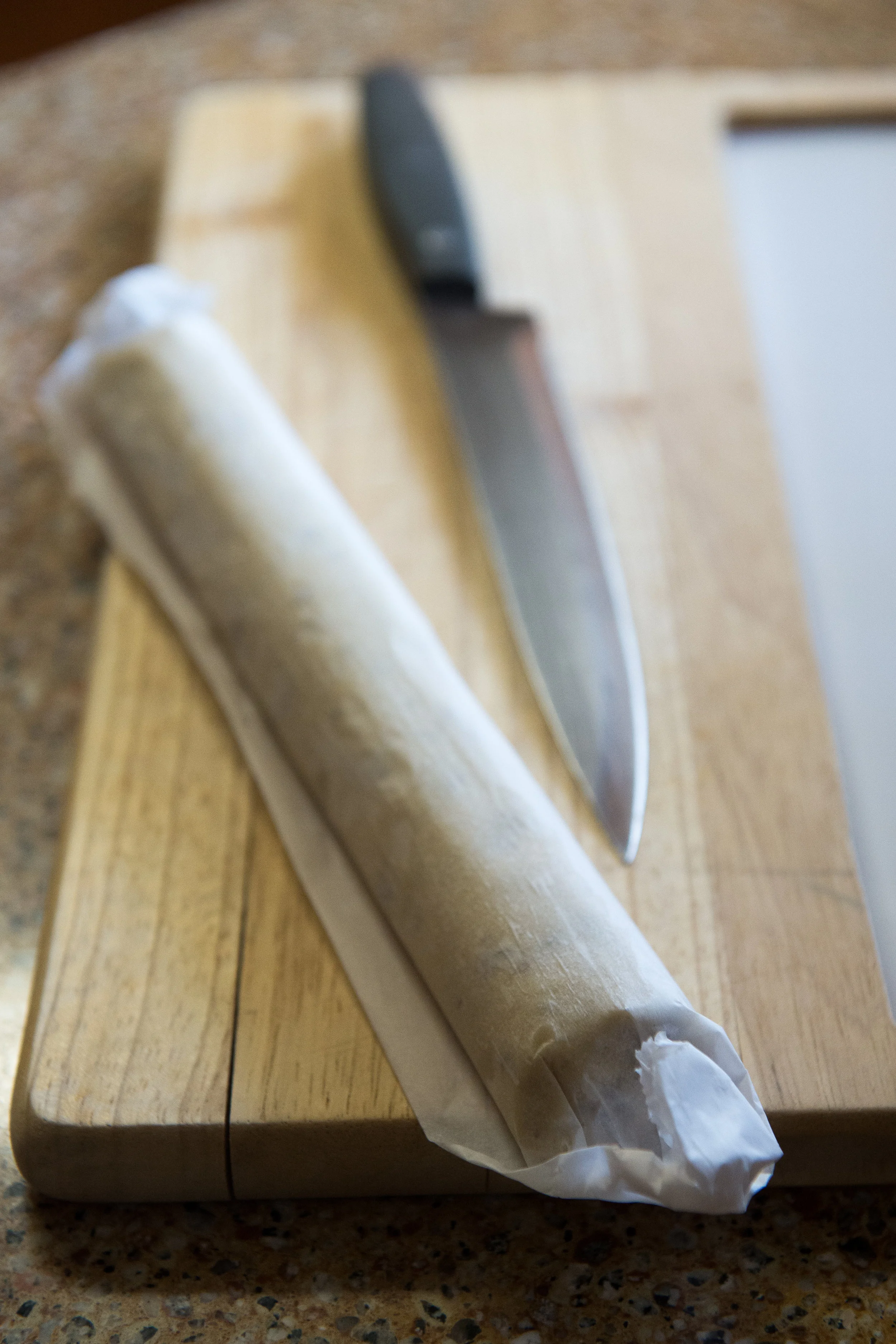 A frozen log of lemon icebox cookie dough, made from a recipe belonging to Lucille Burton, waiting to be sliced and baked. 