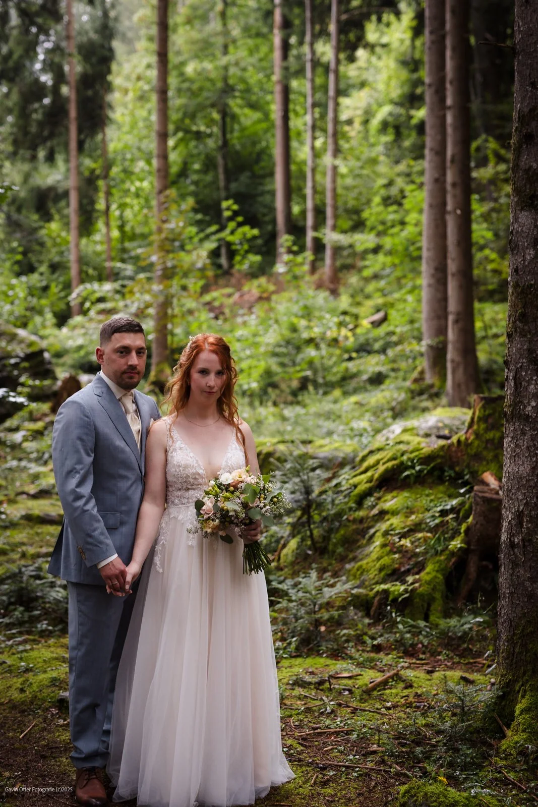 bridal couple in forest on a misty day