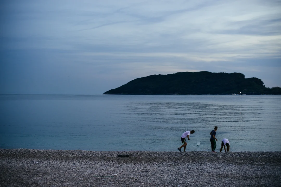 Some local kids skipping rocks into the Adriatic Sea during sunset in Budva.