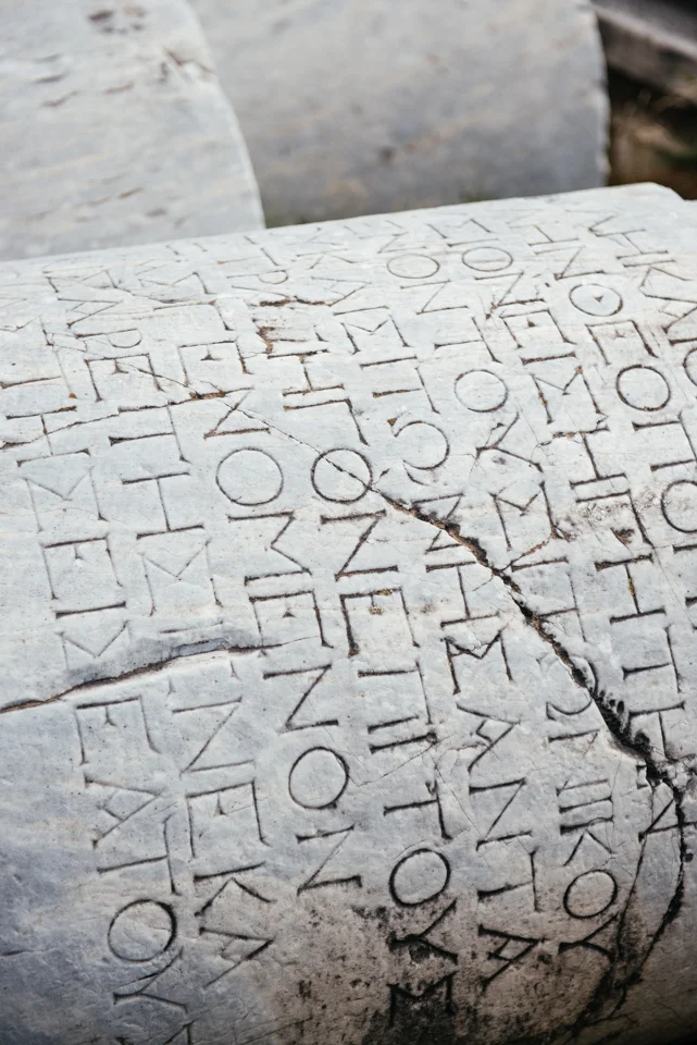 Ancient Roman writing on fallen columns. 