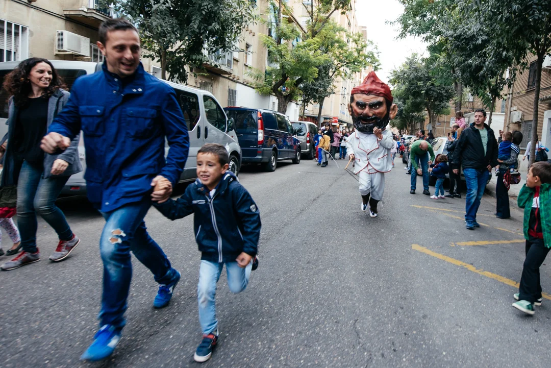 A Big Head chases a father and son with his whip.