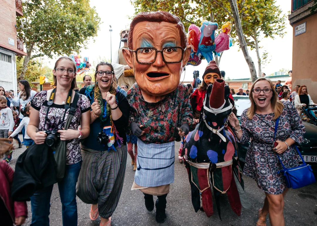 A group of students run along side a Big Head and Nobleman on his "horse."