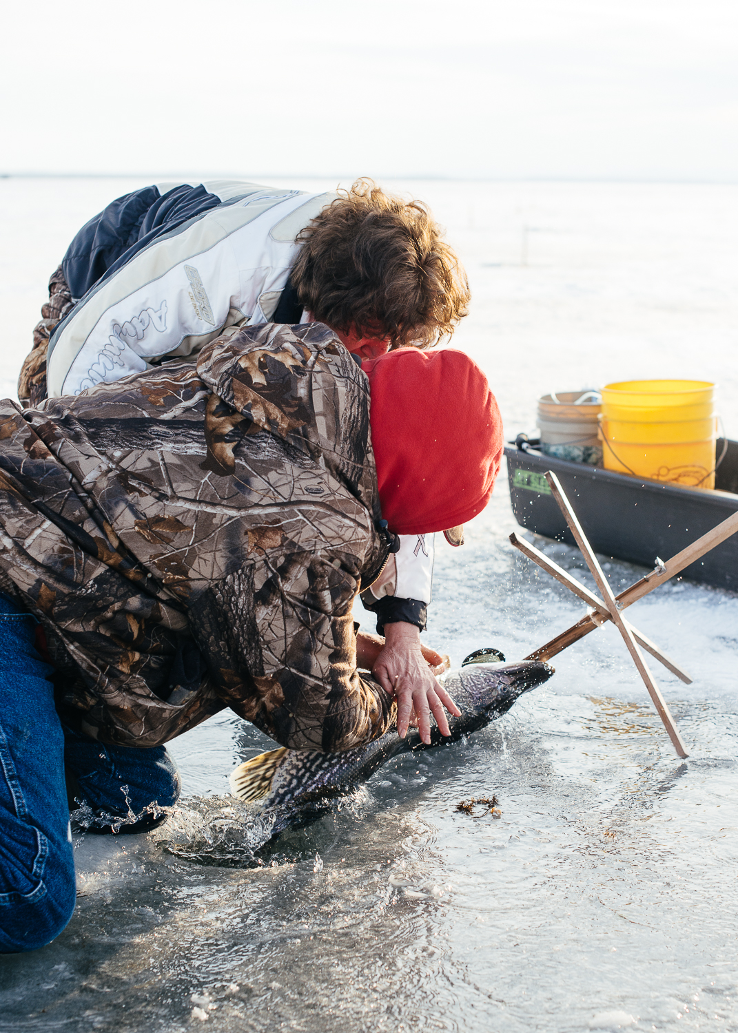 Bob and his wife struggle to keep the Northern Pike from slipping back into the water.