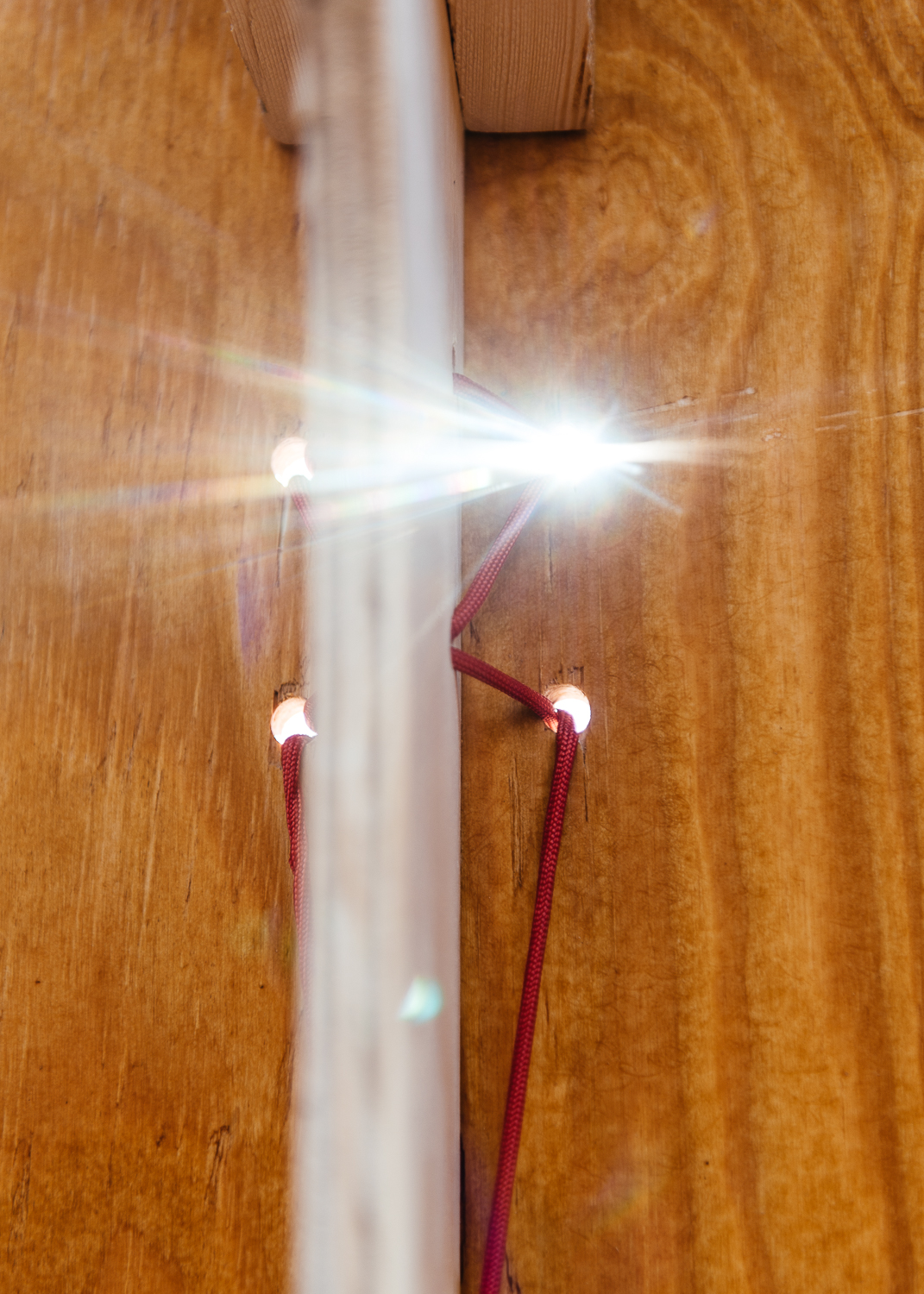 Sun peaking through the paracord holes.