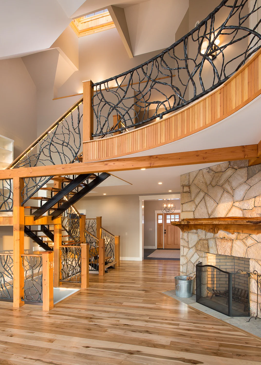 Stone fireplace and the staircase leading to the upper loft.