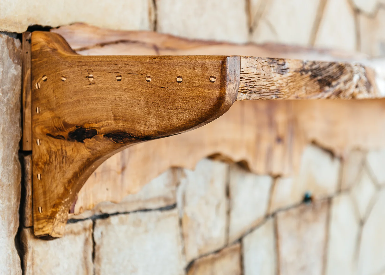 Live edge mantle with custom inlaid plugs. 