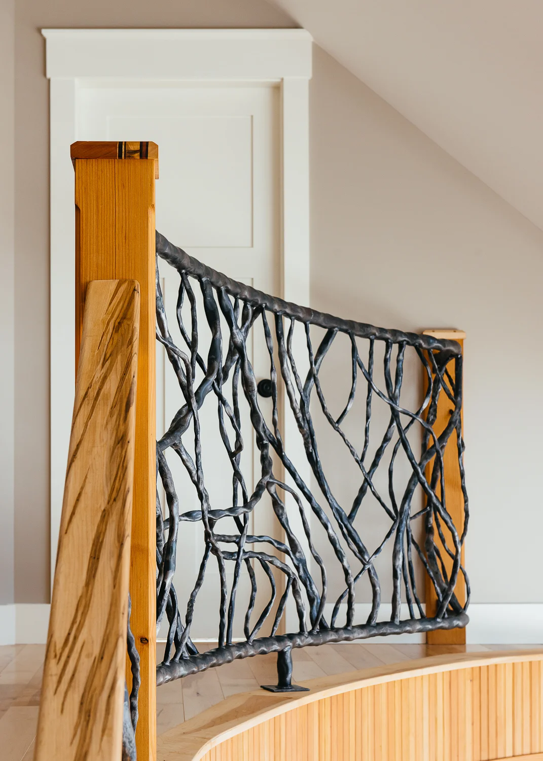 Metal railings shaped like tree branches help bring the feeling of being outside in.
