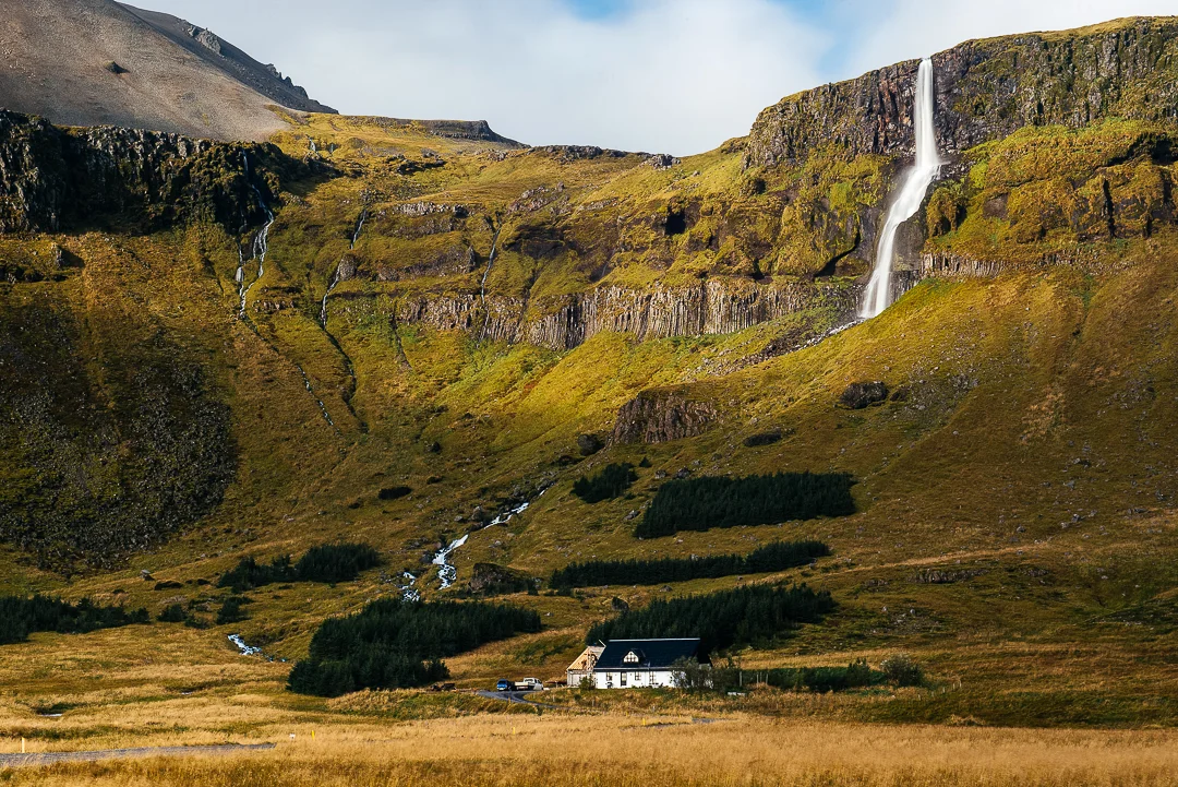 Farm powered by rushing stream of a massive waterfall. 