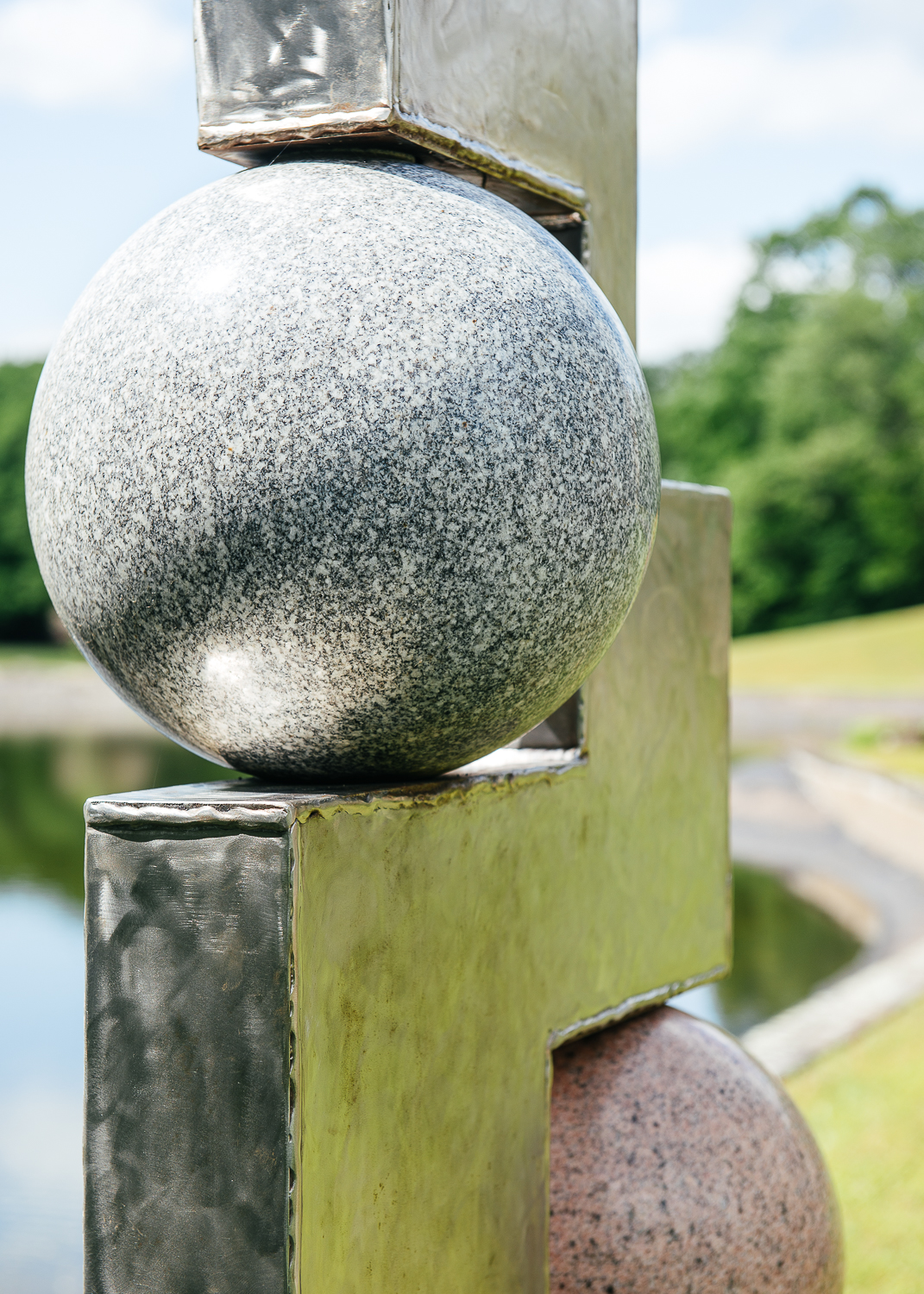 Sculptures surround the pond heading towards the building.