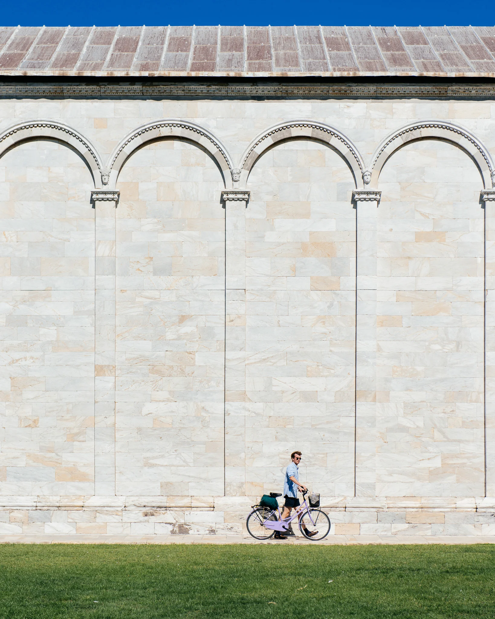 Semester at Sea student walking a bike in Italy.
