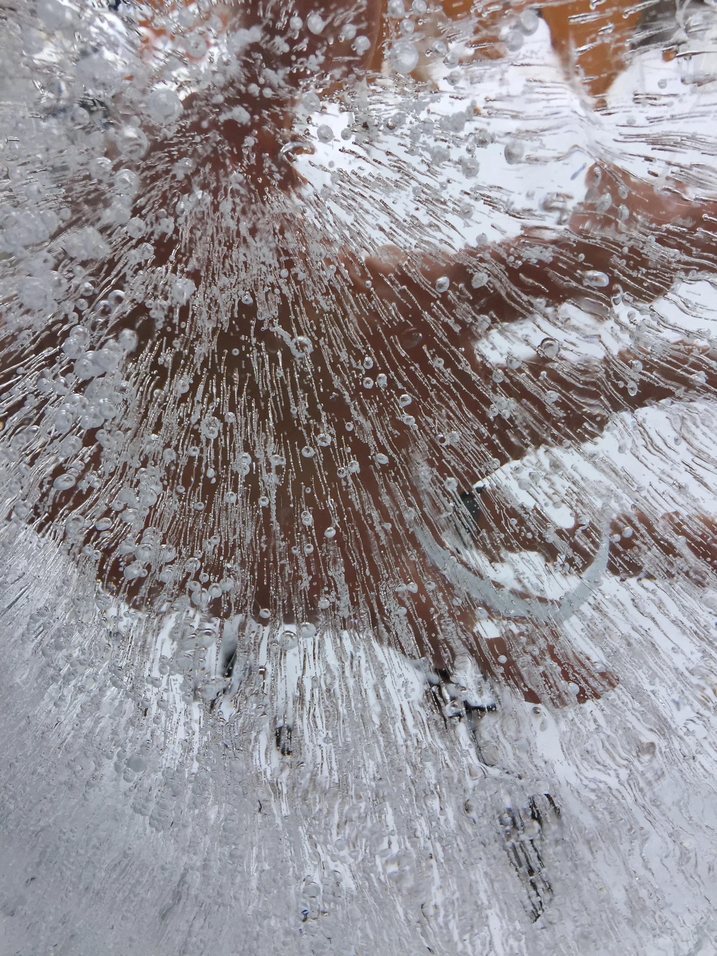 My hand looking through the clear ice