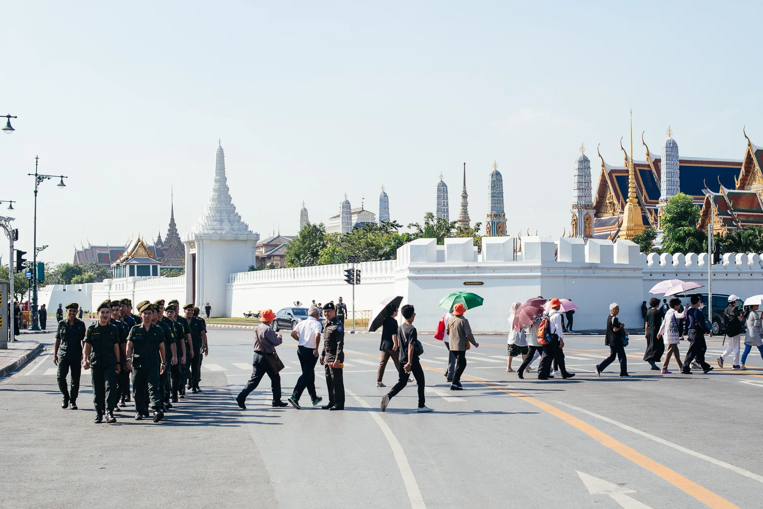 The army of Thailand and people heading to the shrine of the late King Bhumibol Adulyadej.