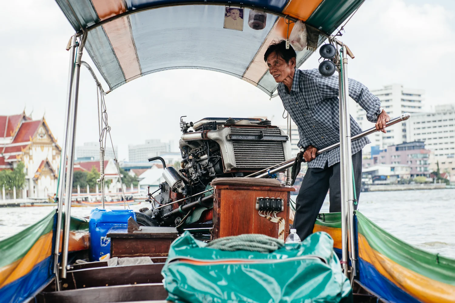 The massive engine on the long-tail boat.