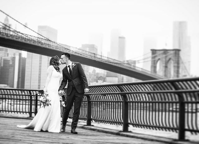 There can never be too many kisses on your wedding day! #brooklynbridgepark #brooklynbridge #dumbo #janescarousel #skyline #weddingphotographer #wedding #weddingplannernyc #elopement #newyorkelopement #newyork #weddinginspo #elopementplanner #newyork