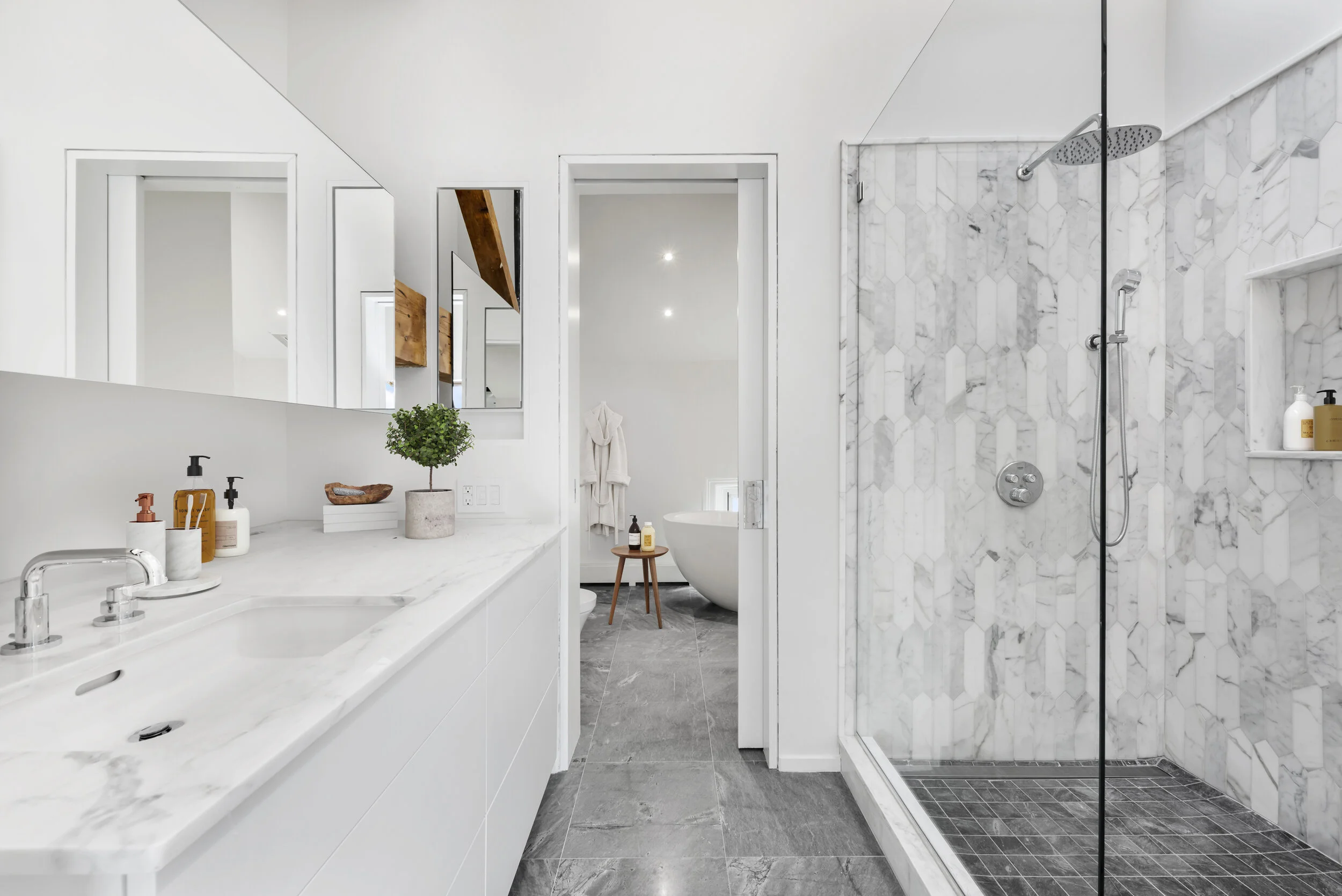The homeowner, a designer with impeccable taste, selected custom tiles for each bathroom.