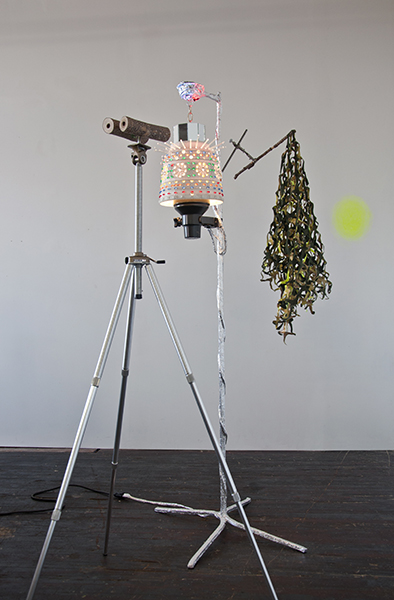 Kim Jong Un with Camo Net and Disembodied Glow Tripod, Branches, Mirrors, Lamp, Aluminum Tape, Pigment, Acrylic, Fabric, Collaboration