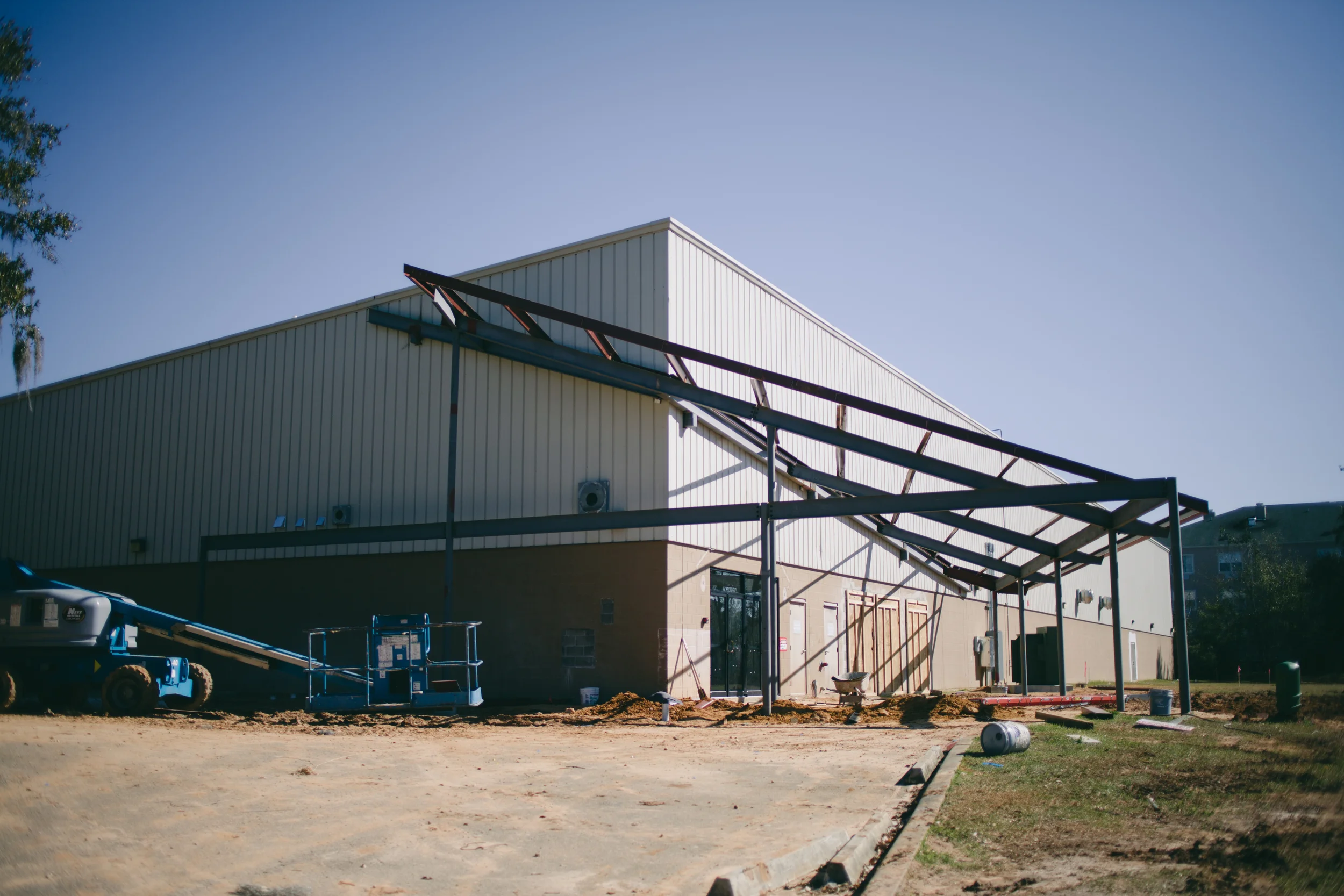Current outside view of building with canopy under construction
