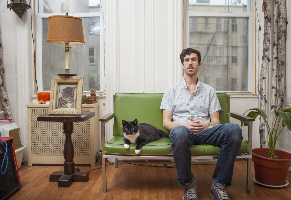 Grant sitting with his cat: Tux