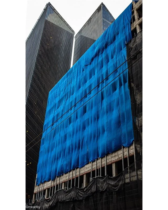 Blue tarp with Penzoil Towers, Houston.