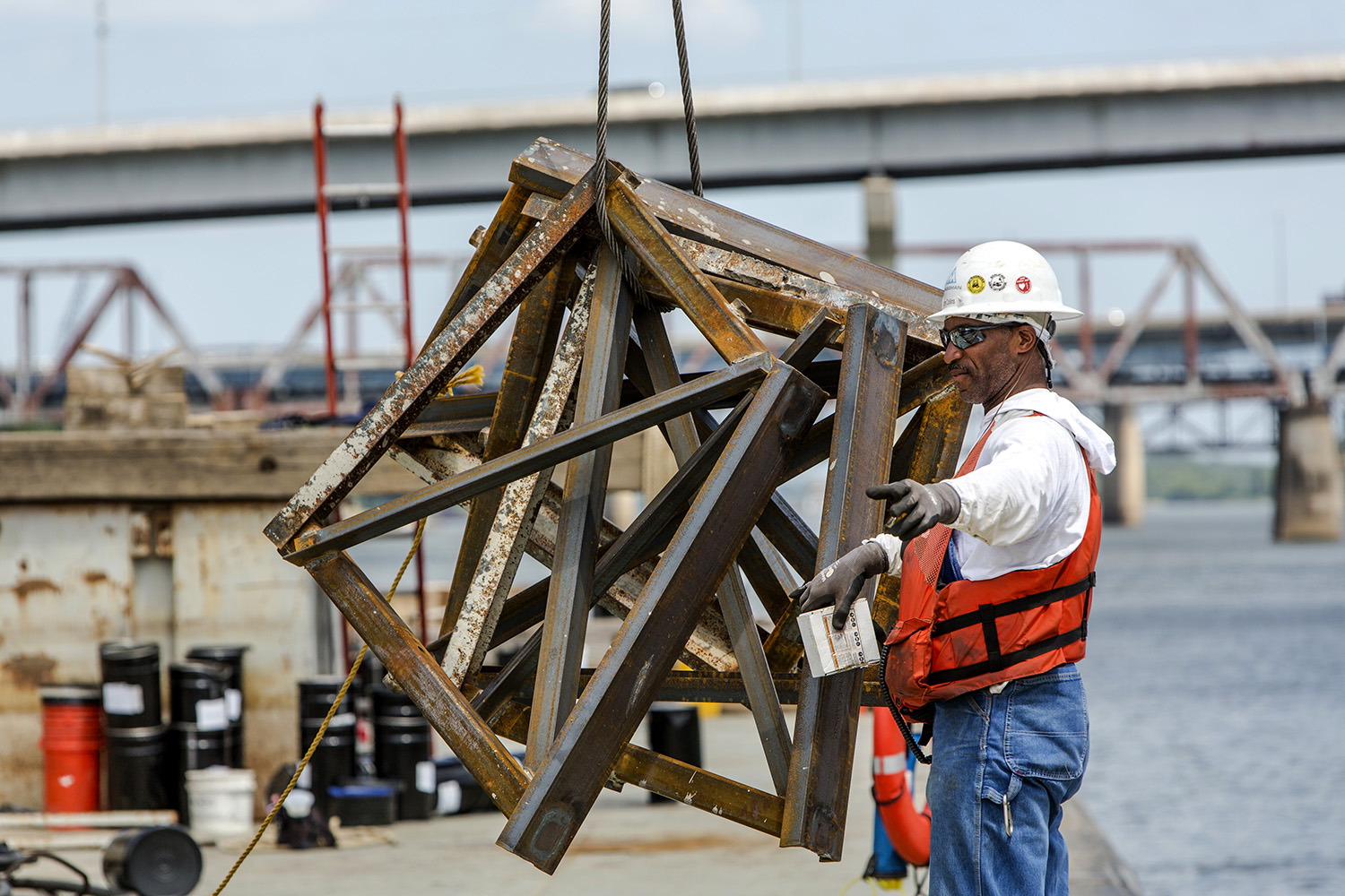  Karen E. Segrave | KES Photo

A worker with Kansas City-based Massman Construction Co., flags the crane while working on the new Broadway Bridge. The Broadway Bridge has been under construction for the last 18 months by Kansas City-based Massman Con