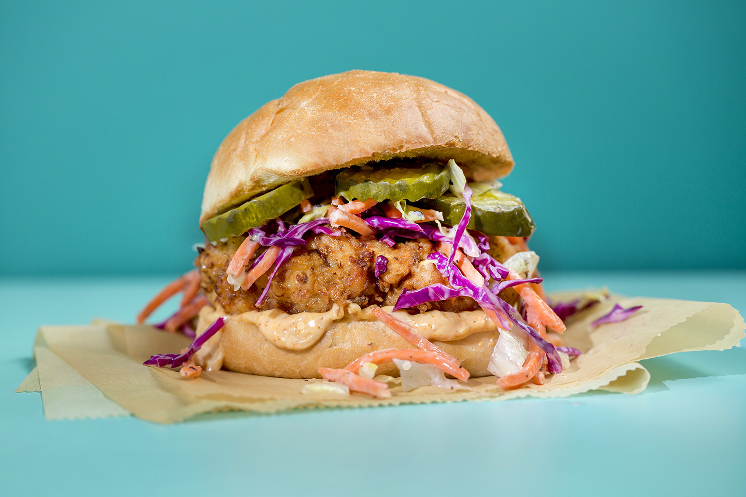 Fried chicken sandwich with slaw and pickles.