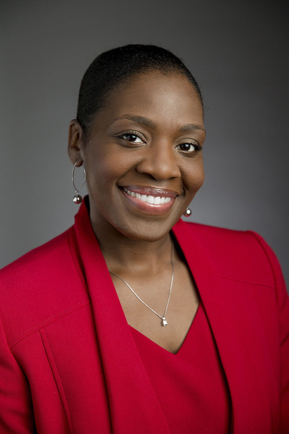african american female executive headshot on grey.JPG